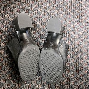 Lightly worn black sandals with a small heel.